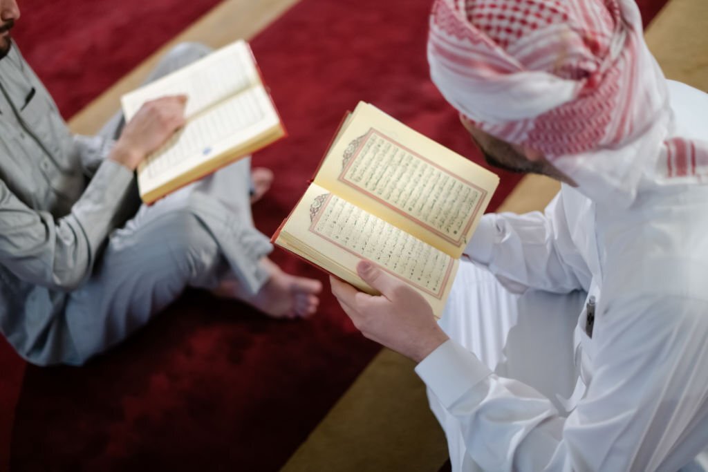 two muslim people in mosque reading quran together concept of islamic education and school of holly book kuran