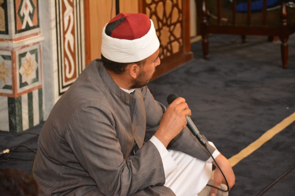 Cairo, Egypt, July 8 2022: A Noble Quran reading ring inside a mosque at the day of Arafah or Arafat before Eid Al-Adha, a group of people reading and learning Quran with an Islamic Imam or preacher