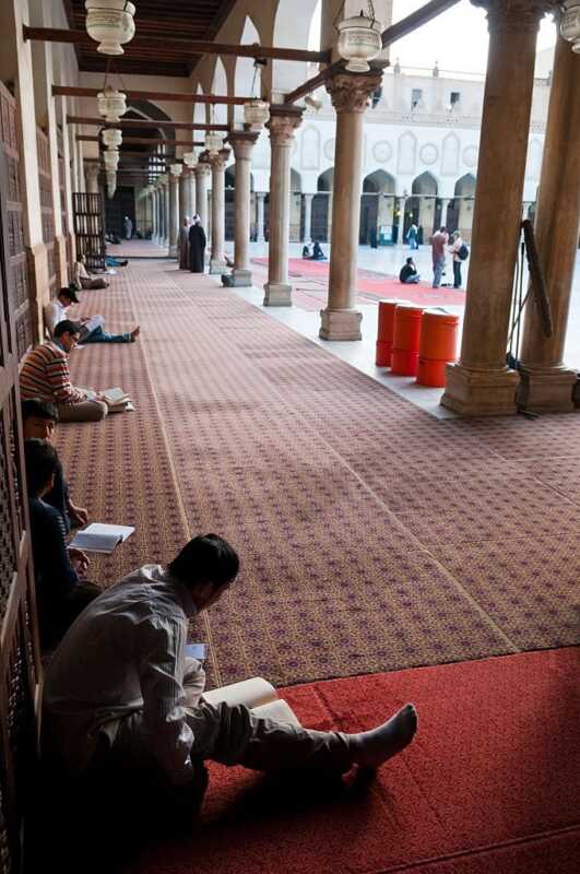 Young men read the Koran in the courtyard of Al-Azhar in Cairo, Egypt