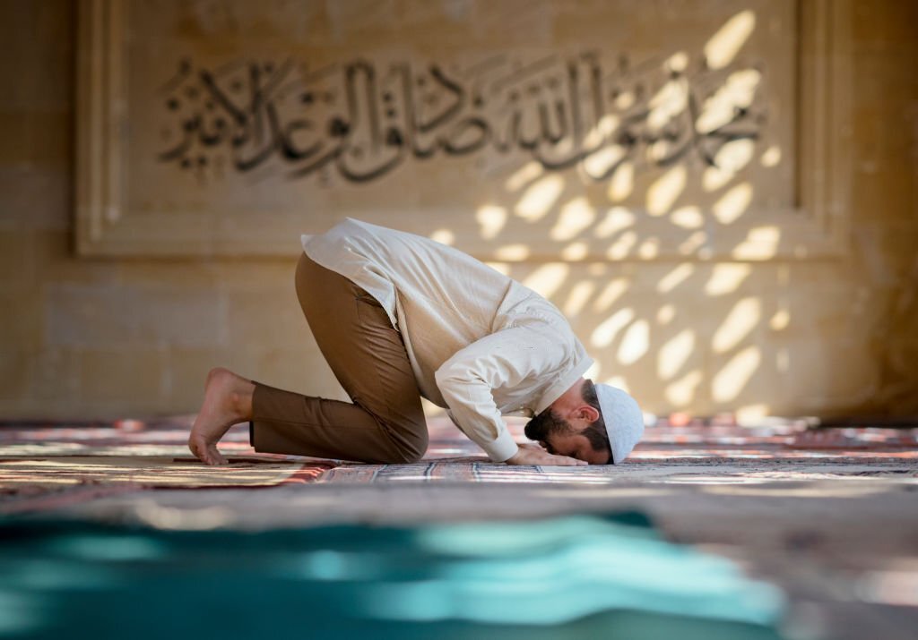 Muslim man is praying in mosque