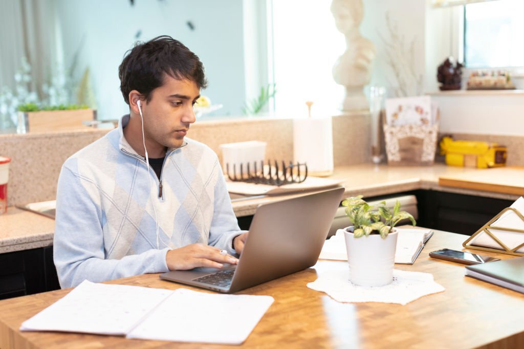 College Student, Young Adult, Home Study - Student studying in the kitchen